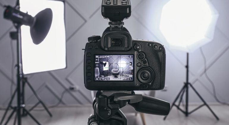 Professional camera on tripod in modern photo studio Professional camera on tripod in modern photo studio
